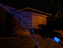 Side view of a GIANT GlowWeb under black light image